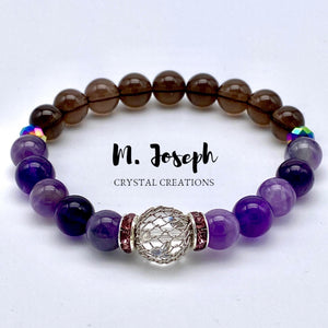 Amethyst and smoky quartz combine in this bracelet to provide a powerful clearing of static energy and an induction of healing.